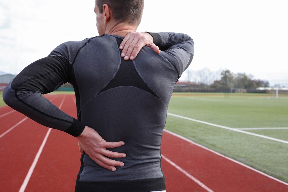Older Male Track Athlete Rubbing His Back