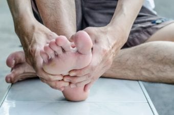 Man Massaging His Own Foot