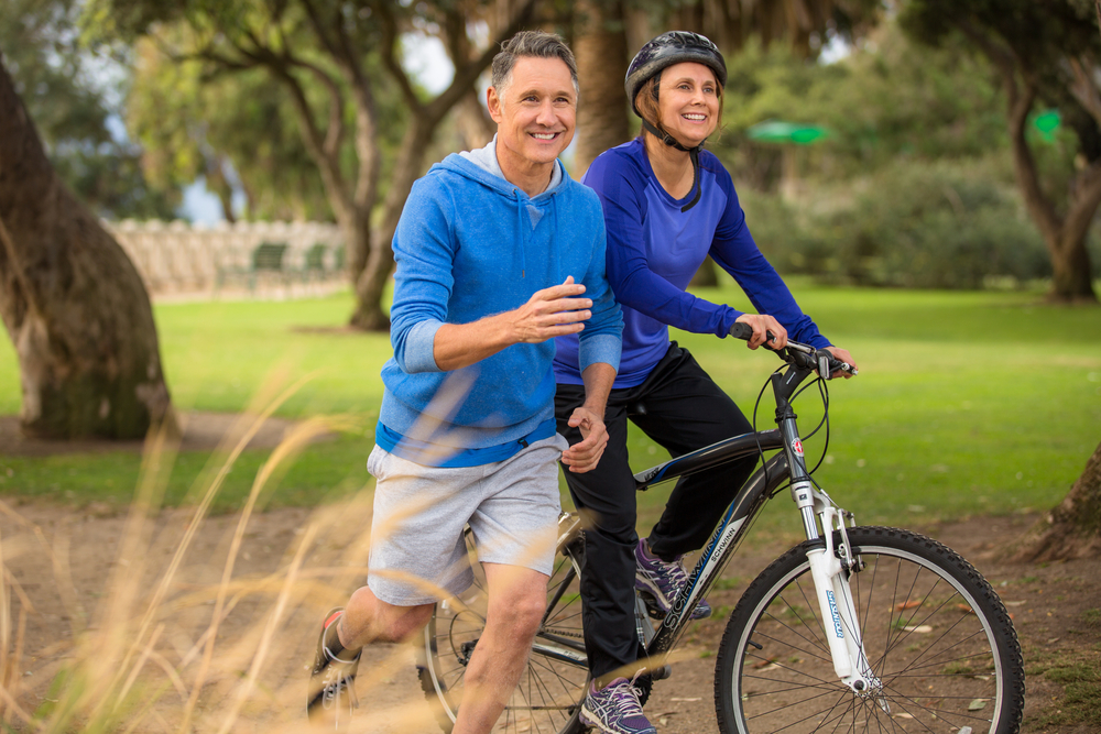 Man and Woman running and biking together
