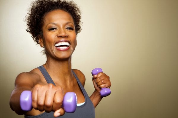 african american woman with arthritis lifting weights