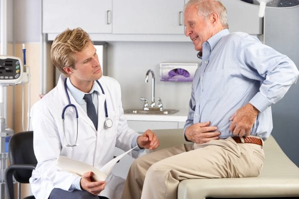 Man explaining to doctor his bursitis hip pain