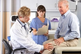 man at doctor with lyme disease knee pain
