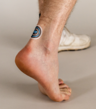 A FIT® Therapy Universal Patch applied near the ankle